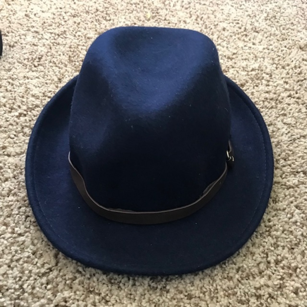 Never worn. Navy fedora hat with brown leather strap and gold buckle